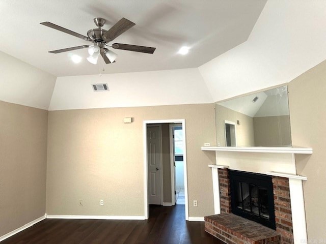 unfurnished living room with a brick fireplace, dark hardwood / wood-style floors, vaulted ceiling, and ceiling fan