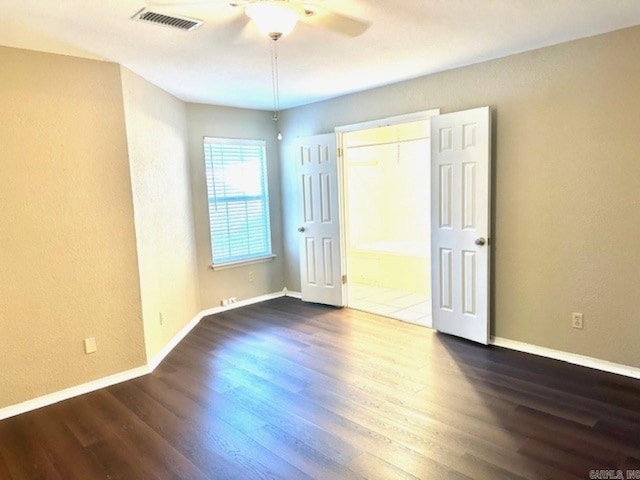 unfurnished bedroom featuring ceiling fan, a closet, and dark hardwood / wood-style floors