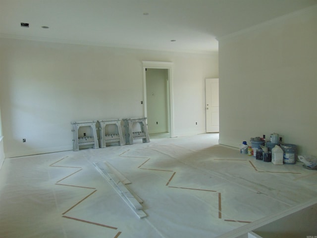 empty room featuring crown molding