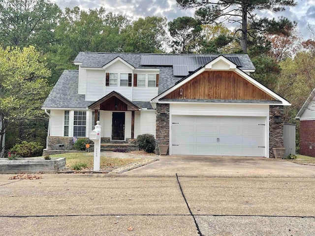 view of front facade with solar panels and a garage