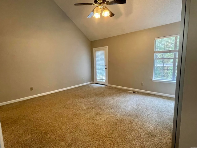 empty room featuring carpet floors, ceiling fan, and lofted ceiling