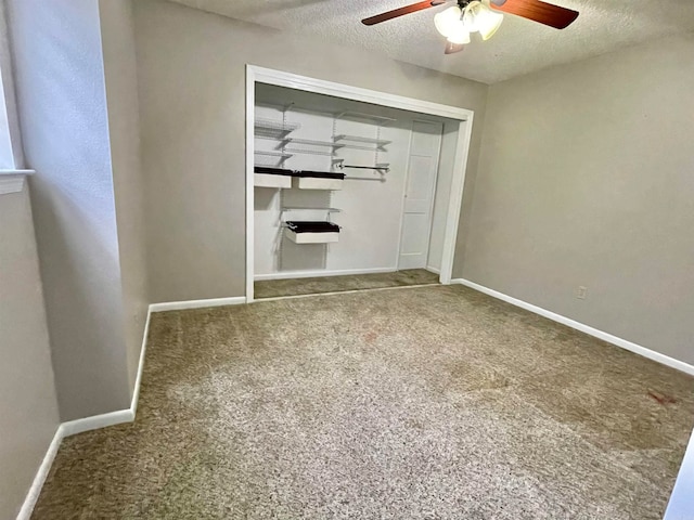 unfurnished bedroom with ceiling fan, a closet, carpet floors, and a textured ceiling