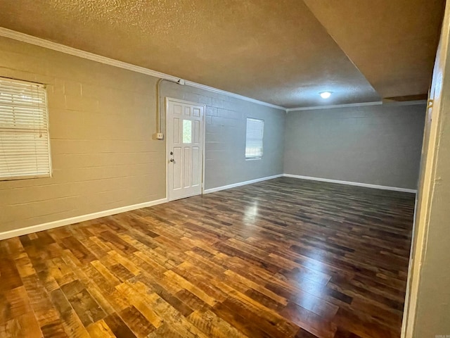 interior space with dark hardwood / wood-style flooring, a textured ceiling, and ornamental molding