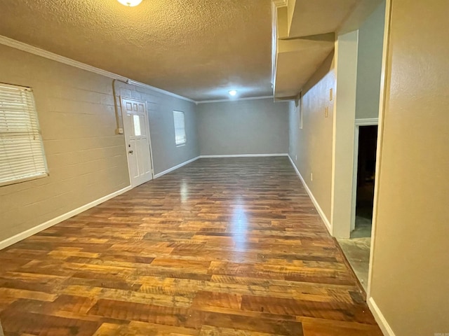 interior space with crown molding, wood-type flooring, and a textured ceiling