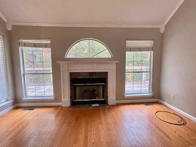 unfurnished living room with light wood-type flooring and crown molding