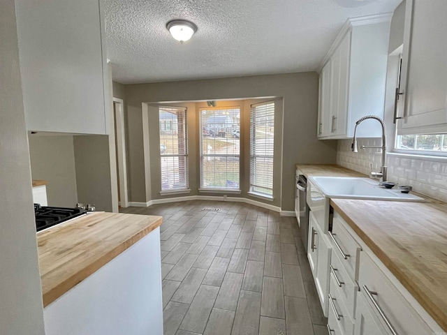 kitchen featuring white cabinetry and butcher block counters