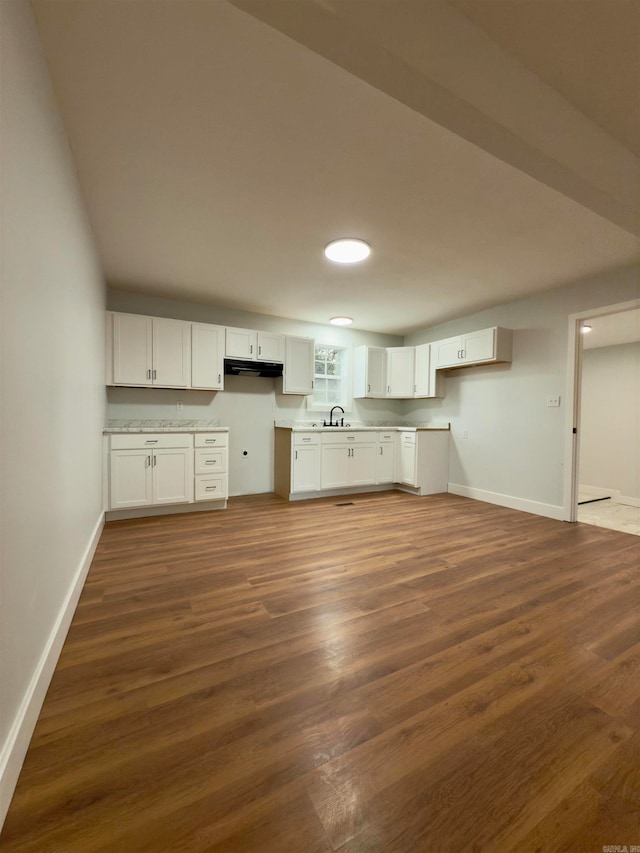 kitchen featuring dark hardwood / wood-style flooring, white cabinets, and sink