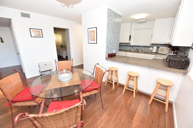 dining space with dark hardwood / wood-style flooring