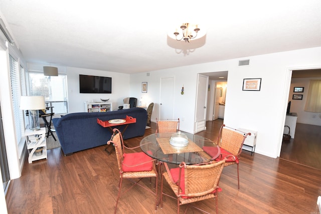 dining area featuring dark wood-type flooring