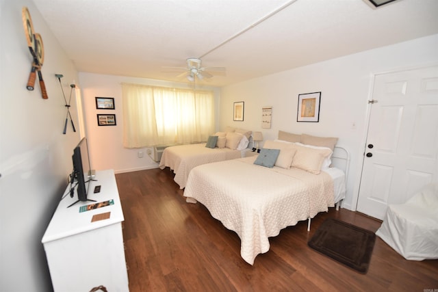 bedroom with dark hardwood / wood-style flooring and ceiling fan