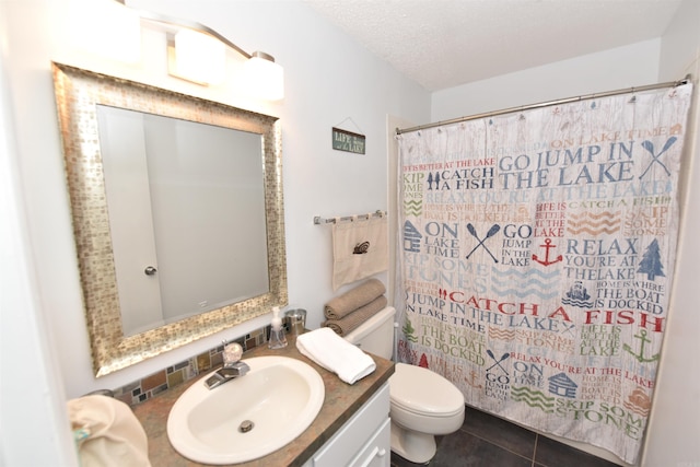 bathroom with a textured ceiling, vanity, tile patterned flooring, toilet, and curtained shower