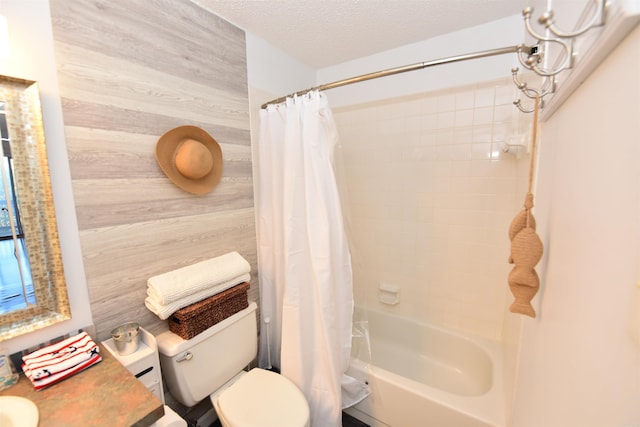 full bathroom featuring vanity, wood walls, toilet, shower / bathtub combination with curtain, and a textured ceiling