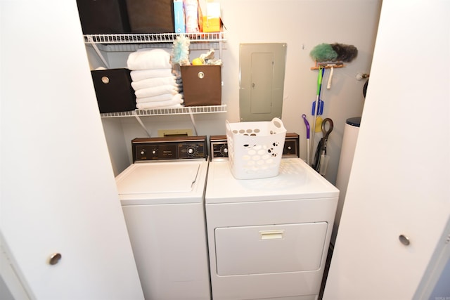 laundry room with washing machine and dryer and electric panel