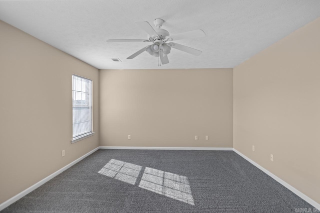 empty room with a textured ceiling, carpet floors, and ceiling fan