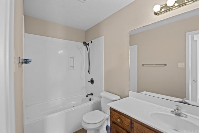 full bathroom featuring  shower combination, vanity, a textured ceiling, and toilet