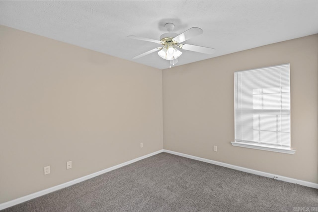 spare room with carpet, ceiling fan, and a textured ceiling