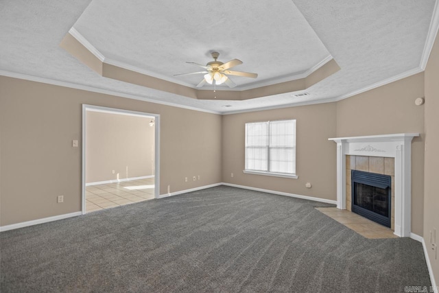 unfurnished living room featuring a raised ceiling, light colored carpet, and ornamental molding