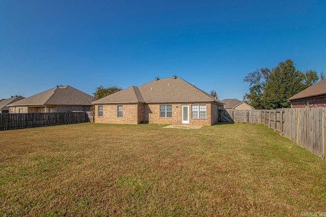 rear view of house with a yard