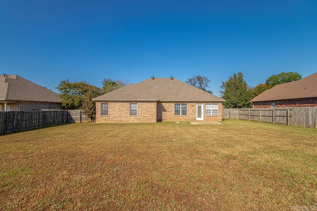 back of house with a lawn