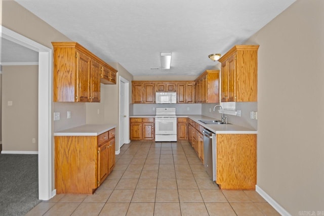 kitchen with a textured ceiling, white appliances, sink, and light tile patterned floors