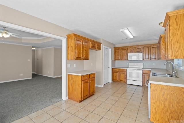 kitchen featuring ceiling fan, sink, light colored carpet, white appliances, and ornamental molding