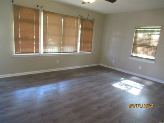 unfurnished room with ceiling fan and dark hardwood / wood-style flooring