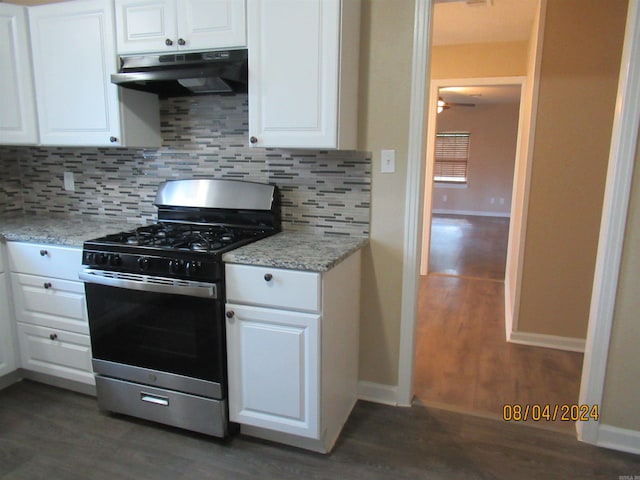 kitchen with tasteful backsplash, stainless steel gas range oven, white cabinetry, and dark hardwood / wood-style flooring