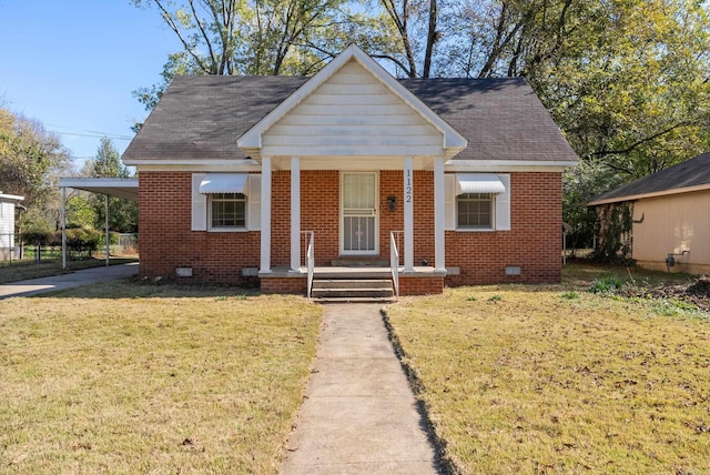 bungalow-style home with a front yard and a carport