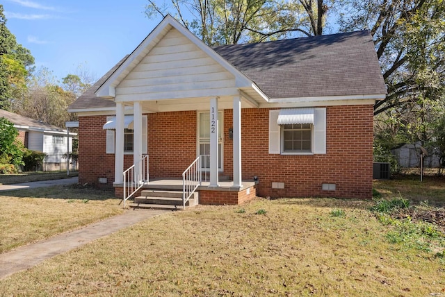 bungalow-style home with cooling unit and a front yard