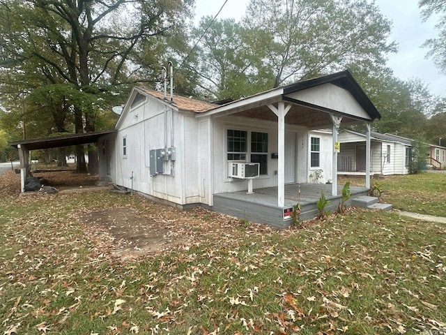 view of front of home featuring covered porch, a carport, and cooling unit