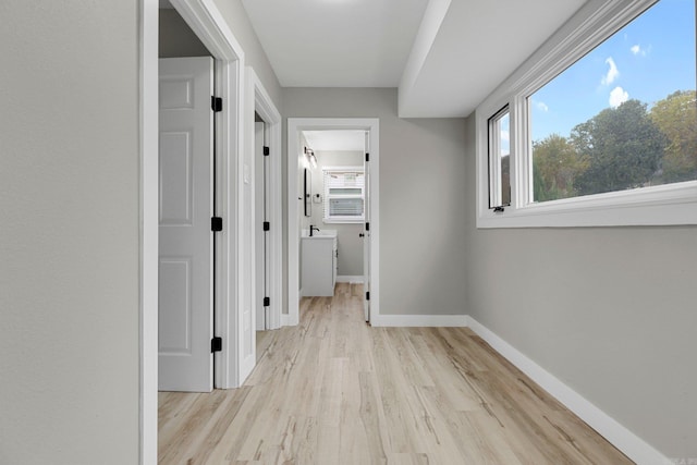 corridor with light wood-type flooring