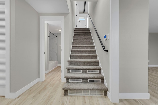 stairs featuring hardwood / wood-style flooring