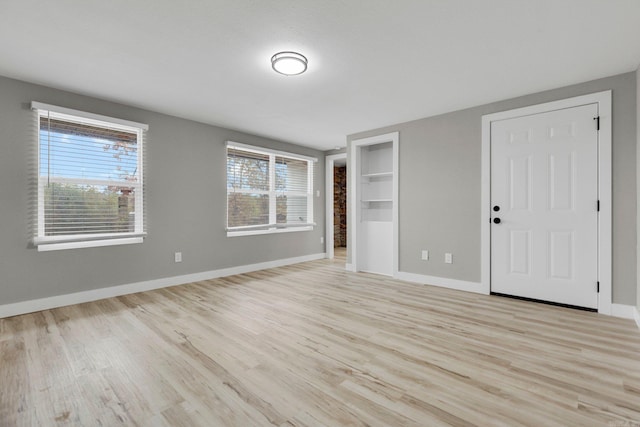 empty room with light hardwood / wood-style flooring