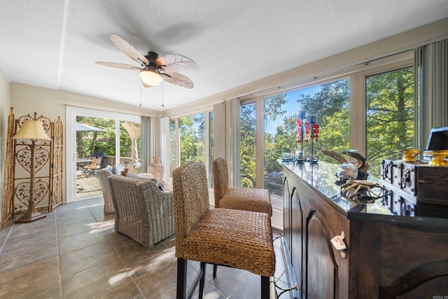 sunroom featuring ceiling fan and a healthy amount of sunlight