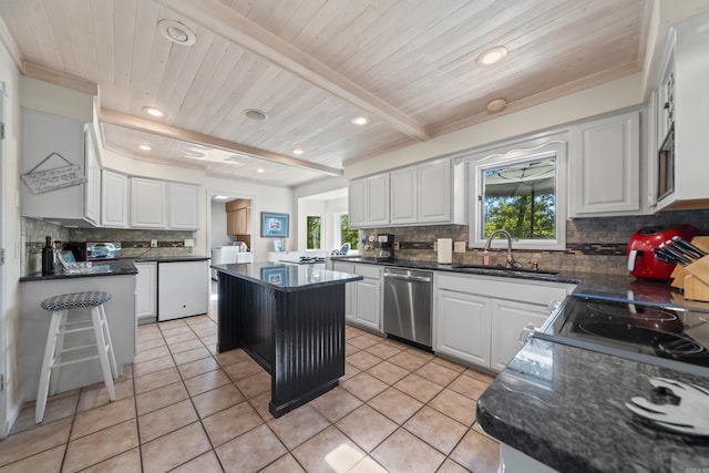 kitchen featuring white cabinets, dishwasher, a kitchen island, and plenty of natural light