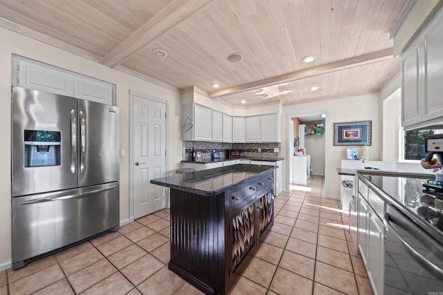 kitchen with white cabinets, appliances with stainless steel finishes, tasteful backsplash, and light tile patterned floors