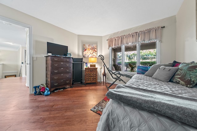 bedroom with dark hardwood / wood-style flooring