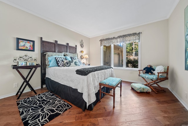 bedroom with wood-type flooring and ornamental molding