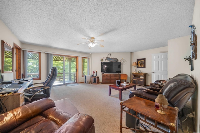 living room featuring ceiling fan, carpet, and a textured ceiling