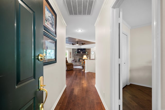 hallway with dark hardwood / wood-style flooring and ornamental molding