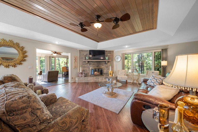 living room with a healthy amount of sunlight, dark wood-type flooring, and wooden ceiling