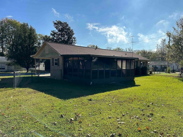 back of house featuring a sunroom and a yard