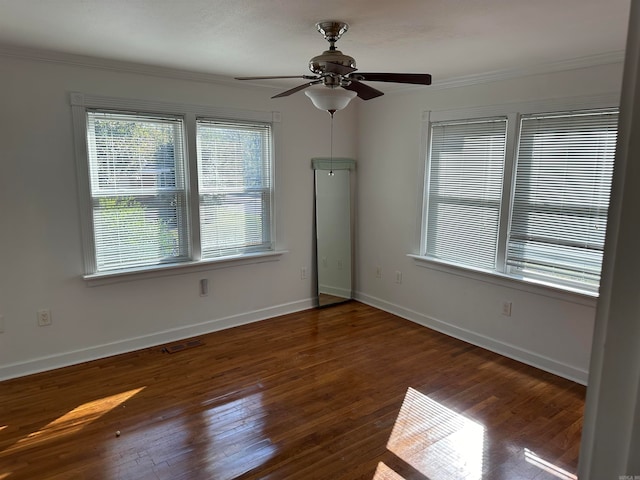 empty room featuring ceiling fan, dark hardwood / wood-style floors, and ornamental molding