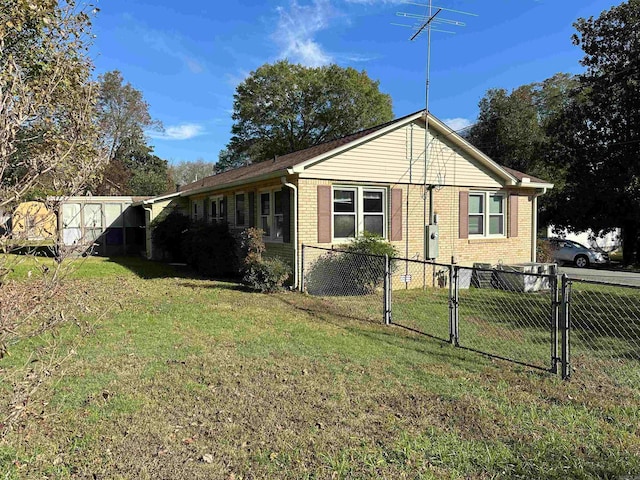 view of side of property with a yard