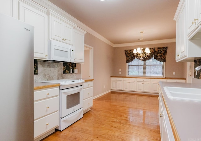 kitchen featuring white cabinetry, light hardwood / wood-style flooring, a chandelier, decorative light fixtures, and white appliances