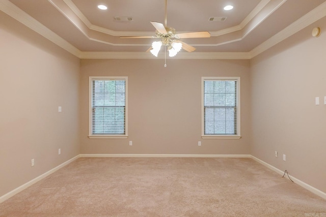 empty room with ceiling fan, light colored carpet, and crown molding