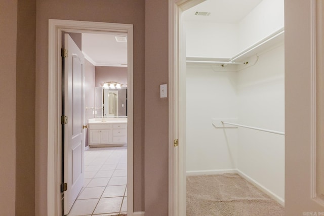 spacious closet featuring light tile patterned floors