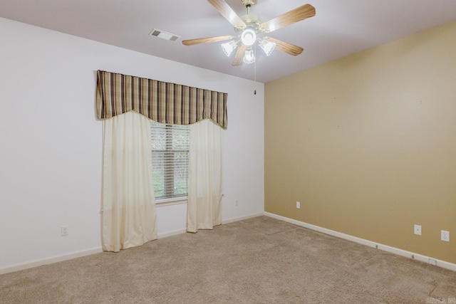 carpeted spare room featuring ceiling fan