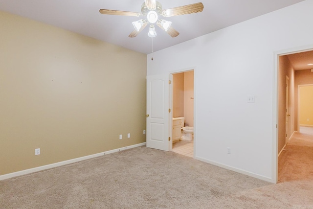 unfurnished bedroom featuring light colored carpet, ceiling fan, and ensuite bathroom