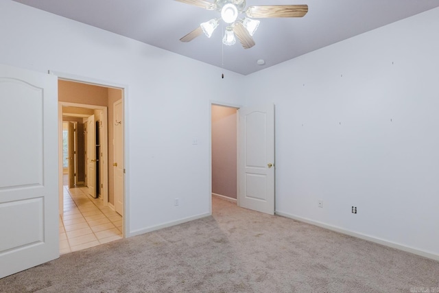 unfurnished bedroom with ceiling fan and light colored carpet